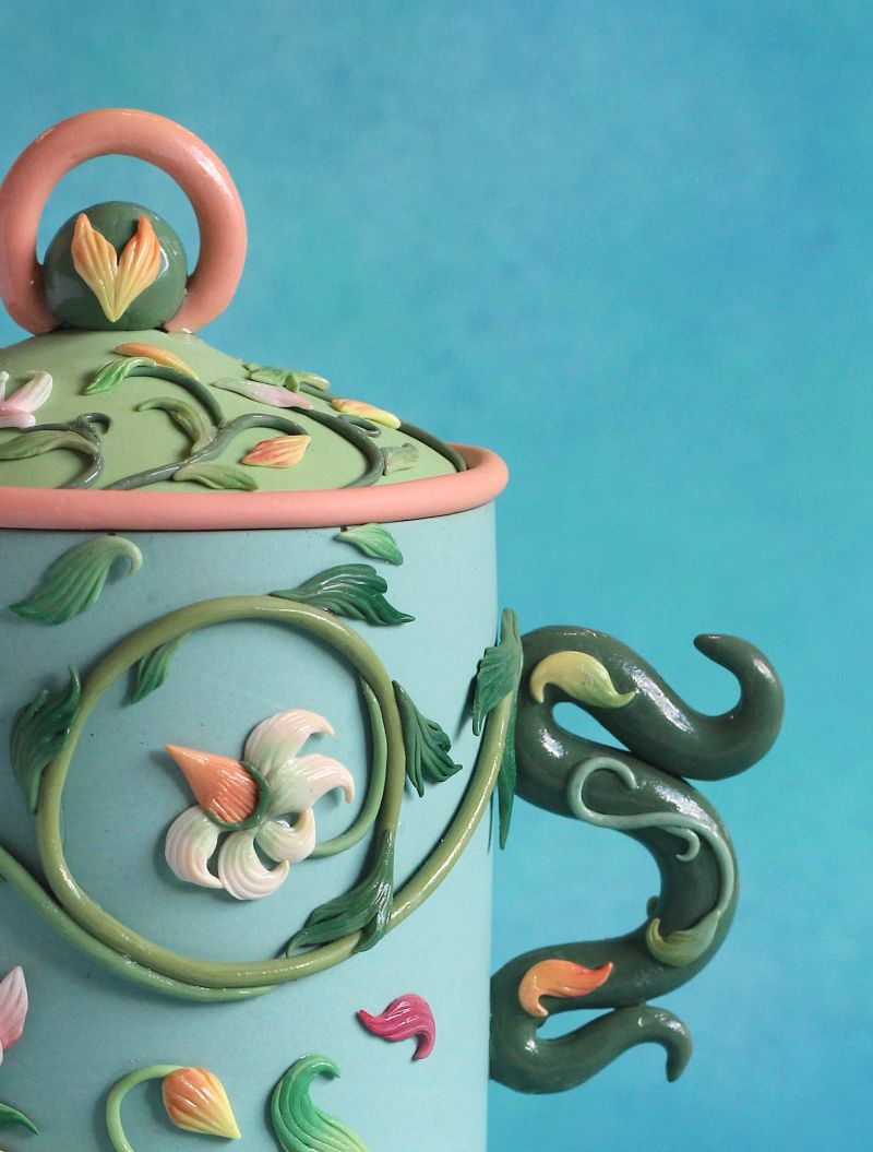 an ornate blue, green and pink snuff pot made of polymer clay