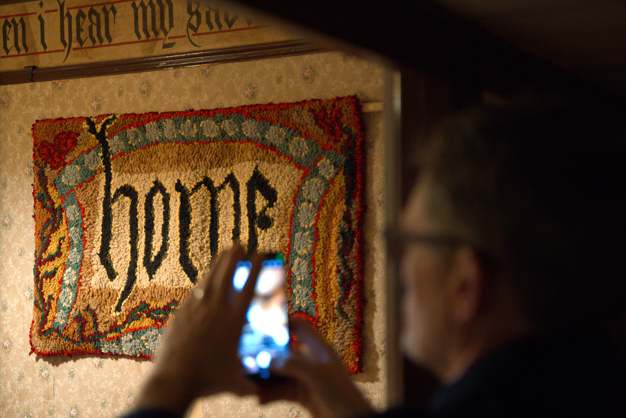Home Rag Rug by Lu Mason and a man taking a photo of the work in the small front bedroom